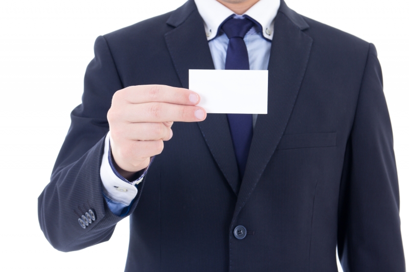 10626711-business-card-in-male-hand-isolated-on-white